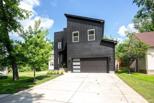 modern home with an attached garage, a front lawn, board and batten siding, and driveway