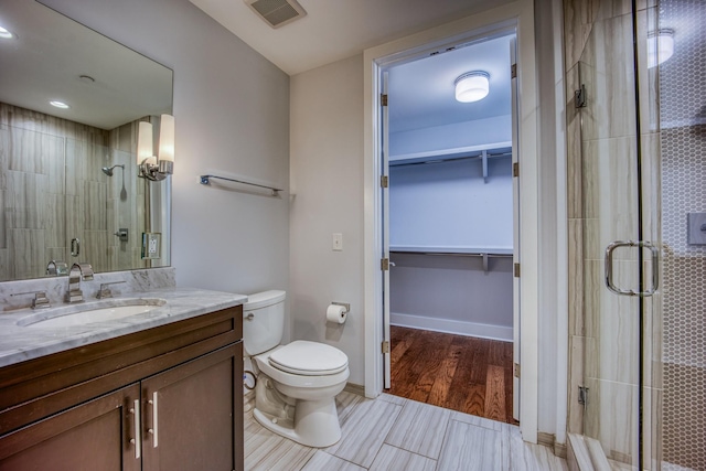 3000 Poston Ave Unit 102, Nashville, TN 37203 - bathroom with vanity, a walk in closet, toilet, a shower stall, and visible vents