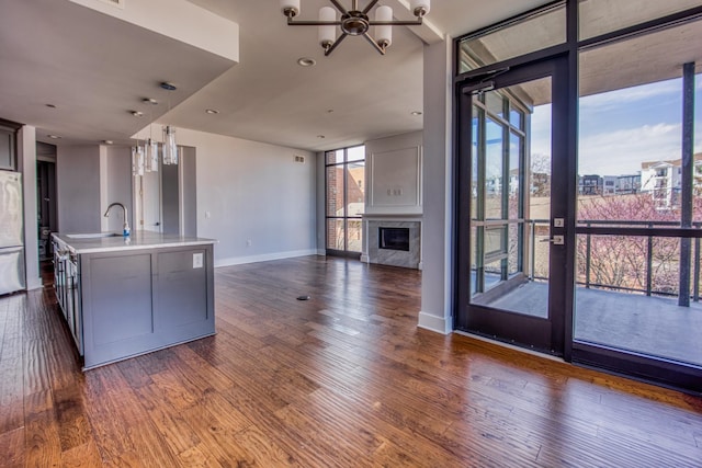 3000 Poston Ave Unit 102, Nashville, TN 37203 - kitchen with open floor plan, light countertops, floor to ceiling windows, and dark wood-type flooring
