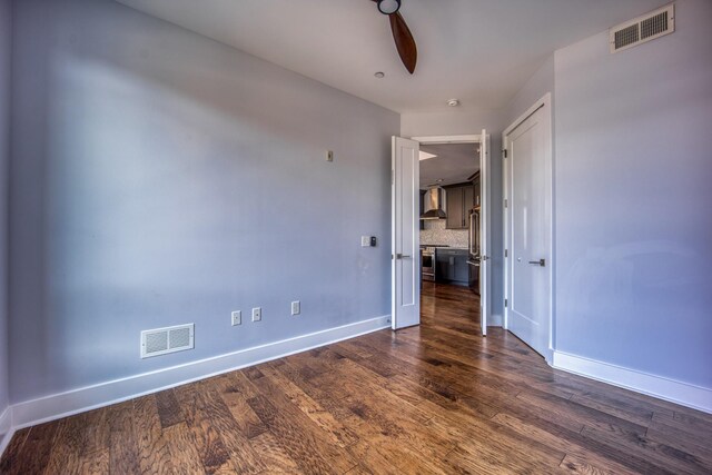 3000 Poston Ave Unit 102, Nashville, TN 37203 - unfurnished bedroom featuring baseboards, dark wood-style floors, and visible vents