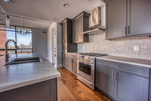 3000 Poston Ave Unit 102, Nashville, TN 37203 - kitchen with backsplash, a sink, wall chimney exhaust hood, stainless steel range with gas cooktop, and dark wood-type flooring