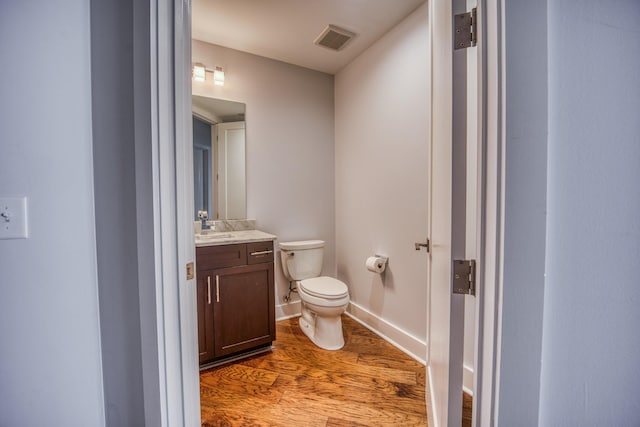 3000 Poston Ave Unit 102, Nashville, TN 37203 - bathroom with toilet, vanity, wood finished floors, baseboards, and visible vents