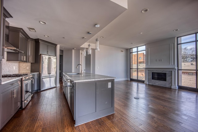 3000 Poston Ave Unit 102, Nashville, TN 37203 - kitchen featuring visible vents, stainless steel appliances, tasteful backsplash, expansive windows, and open floor plan