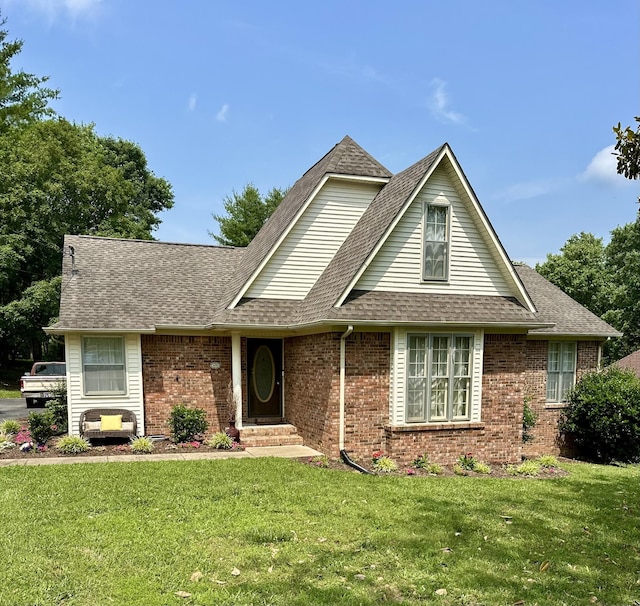 1070 Cliff White Rd, Columbia, TN 38401 - view of front of home featuring brick siding, roof with shingles, and a front lawn