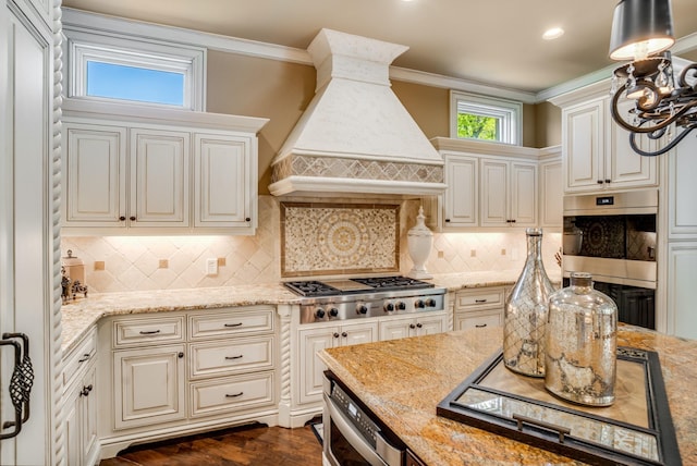 947 Tyne Blvd, Nashville, TN 37220 - kitchen featuring stainless steel gas cooktop, crown molding, custom range hood, light stone countertops, and stovetop