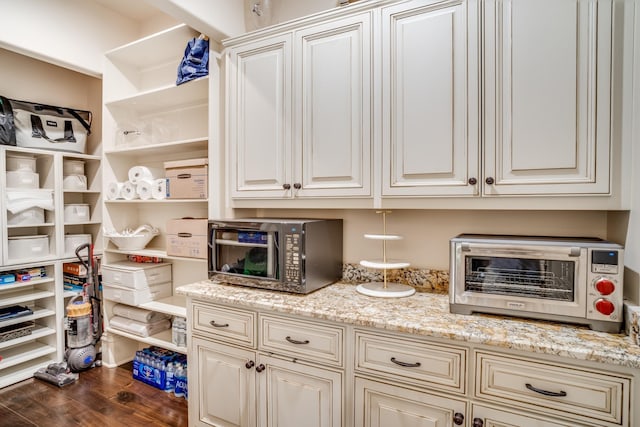947 Tyne Blvd, Nashville, TN 37220 - kitchen featuring open shelves, black microwave, light stone countertops, dark wood-style floors, and cream cabinetry