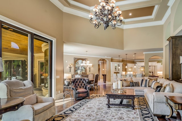 947 Tyne Blvd, Nashville, TN 37220 - living area with arched walkways, ornamental molding, wood finished floors, and a notable chandelier
