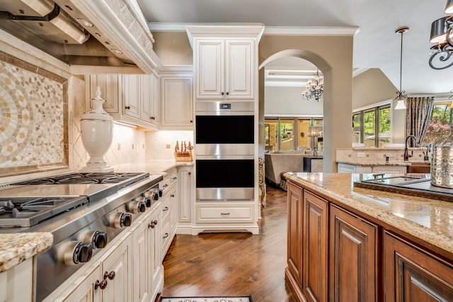 947 Tyne Blvd, Nashville, TN 37220 - kitchen with stainless steel appliances, dark wood-type flooring, under cabinet range hood, backsplash, and light stone counters