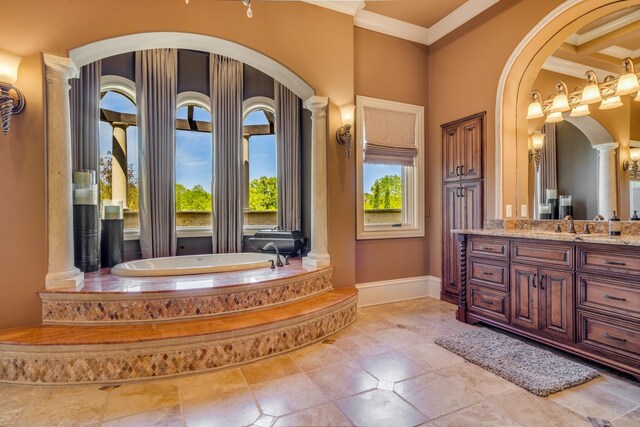 947 Tyne Blvd, Nashville, TN 37220 - bathroom featuring decorative columns, vanity, a bath, baseboards, and ornamental molding