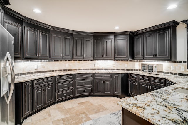 947 Tyne Blvd, Nashville, TN 37220 - kitchen featuring light stone countertops, tasteful backsplash, stainless steel refrigerator with ice dispenser, a toaster, and recessed lighting