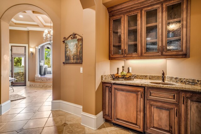 947 Tyne Blvd, Nashville, TN 37220 - bar with baseboards, arched walkways, a sink, indoor wet bar, and coffered ceiling