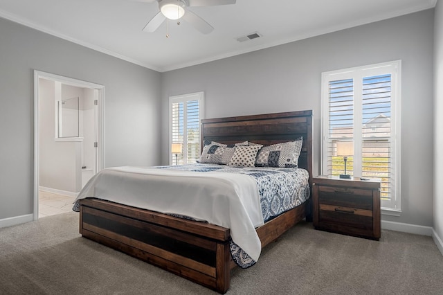 carpeted bedroom featuring a ceiling fan, baseboards, visible vents, and ornamental molding