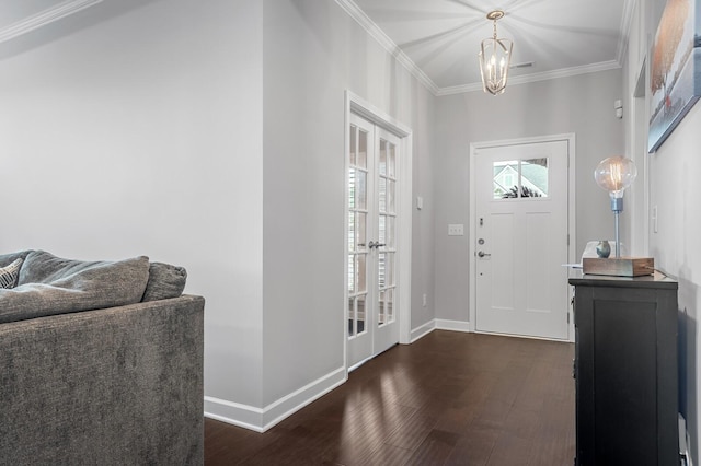 foyer featuring baseboards, ornamental molding, dark wood finished floors, and a chandelier
