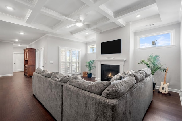 living area with baseboards, a ceiling fan, a warm lit fireplace, and dark wood-style floors