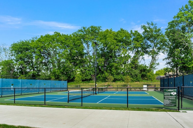 view of tennis court featuring fence