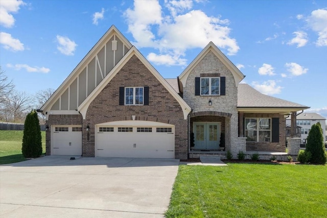view of front of home with concrete driveway, a front yard, brick siding, board and batten siding, and french doors