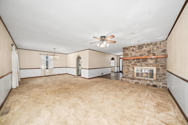 5651 S York Hwy, Grimsley, TN 38565 - unfurnished living room with crown molding, carpet flooring, ceiling fan with notable chandelier, a textured ceiling, and a fireplace