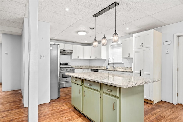 5651 S York Hwy, Grimsley, TN 38565 - kitchen featuring under cabinet range hood, light wood-style flooring, stainless steel appliances, and green cabinetry