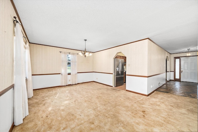 5651 S York Hwy, Grimsley, TN 38565 - carpeted spare room with a textured ceiling, crown molding, baseboards, and an inviting chandelier