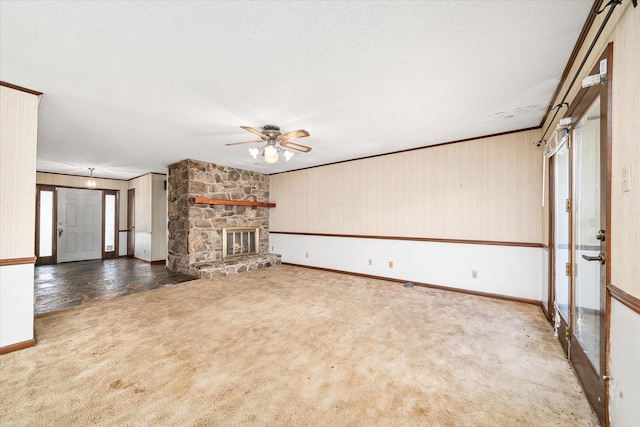 5651 S York Hwy, Grimsley, TN 38565 - unfurnished living room featuring baseboards, carpet floors, ceiling fan, and a stone fireplace