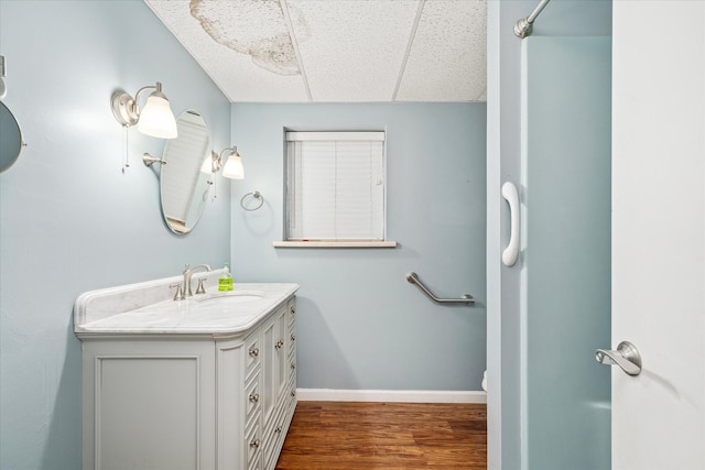 5651 S York Hwy, Grimsley, TN 38565 - bathroom with baseboards, wood finished floors, vanity, and a paneled ceiling