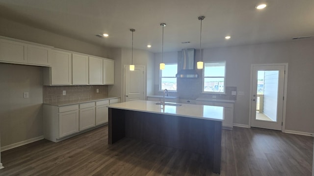 6139 Saxlingham Pl, Smyrna, TN 37167 - kitchen featuring wall chimney range hood, backsplash, dark wood-style flooring, a sink, and white cabinets