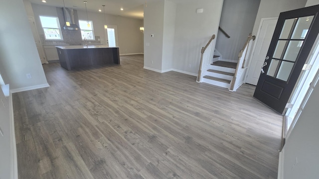 6139 Saxlingham Pl, Smyrna, TN 37167 - unfurnished living room featuring baseboards, recessed lighting, wood finished floors, and stairway