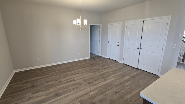 6139 Saxlingham Pl, Smyrna, TN 37167 - unfurnished dining area featuring baseboards, a chandelier, and dark wood-style floors