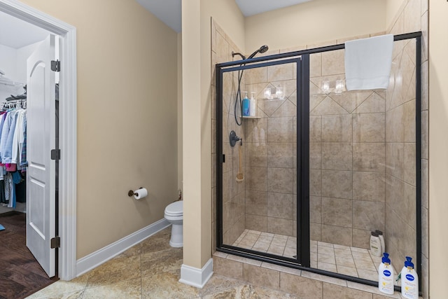 1019 Club View Dr, Gallatin, TN 37066 - bathroom with baseboards, toilet, a stall shower, and a spacious closet