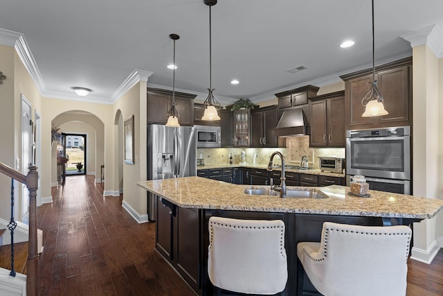 1019 Club View Dr, Gallatin, TN 37066 - kitchen featuring tasteful backsplash, arched walkways, dark brown cabinetry, appliances with stainless steel finishes, and a sink