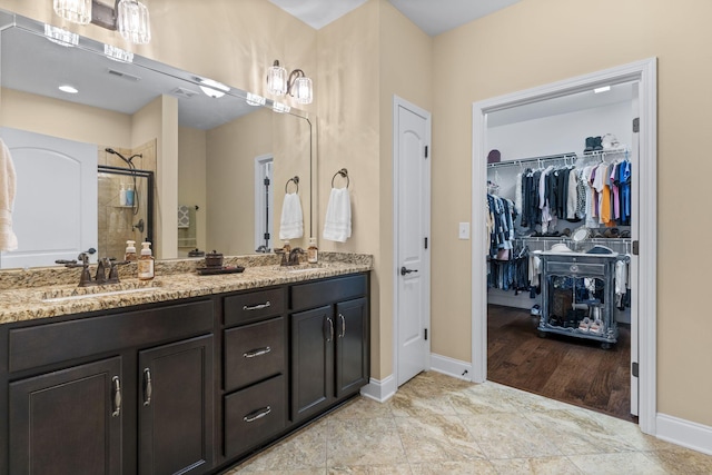 1019 Club View Dr, Gallatin, TN 37066 - full bathroom featuring a spacious closet, baseboards, a sink, a stall shower, and double vanity