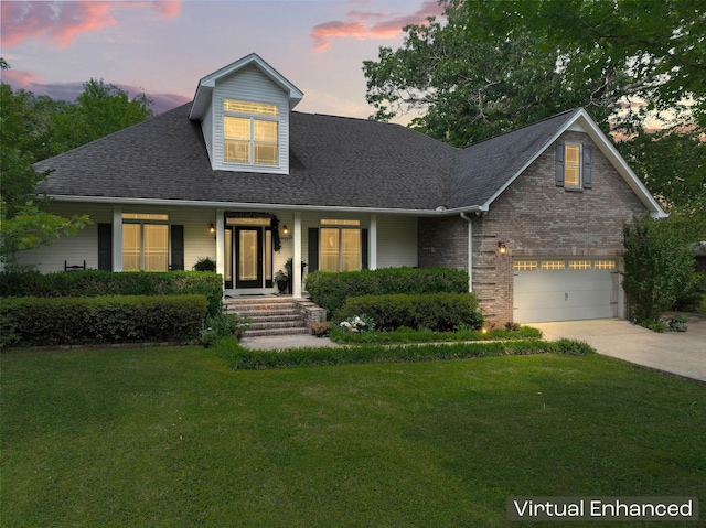 view of front of house featuring concrete driveway, a garage, a yard, and a shingled roof