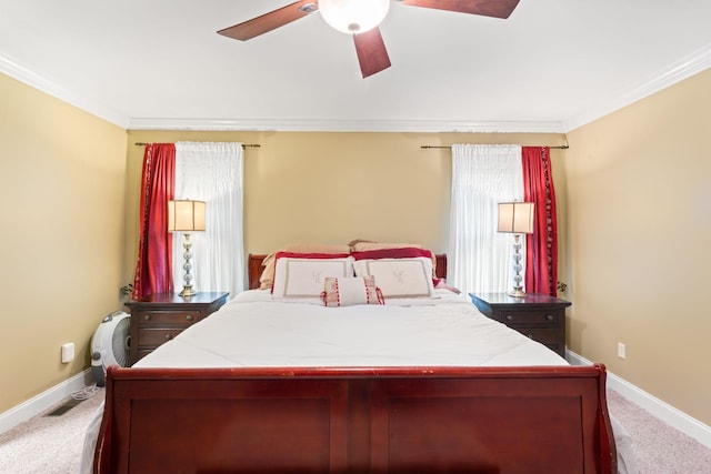 bedroom with carpet floors, ornamental molding, baseboards, and ceiling fan