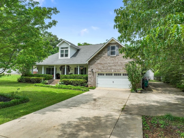 cape cod home featuring brick siding, driveway, a shingled roof, and a front lawn