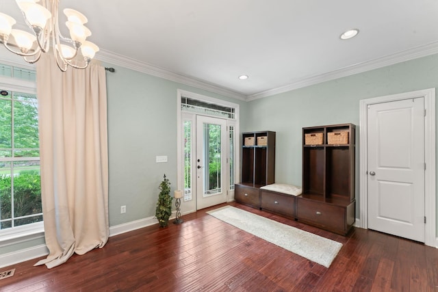 interior space featuring an inviting chandelier, ornamental molding, and a wealth of natural light