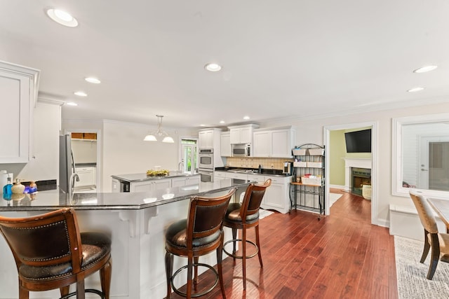 kitchen featuring ornamental molding, a sink, dark countertops, and backsplash