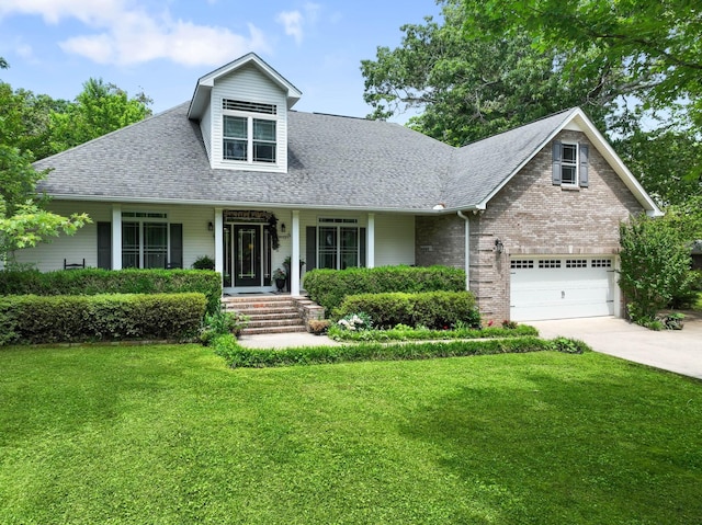 view of front of home with a front yard, roof with shingles, concrete driveway, brick siding, and a garage
