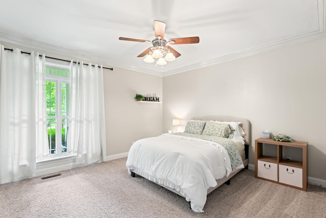 carpeted bedroom with baseboards, ornamental molding, and visible vents