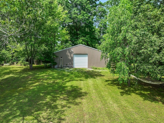 view of yard with a garage and an outdoor structure