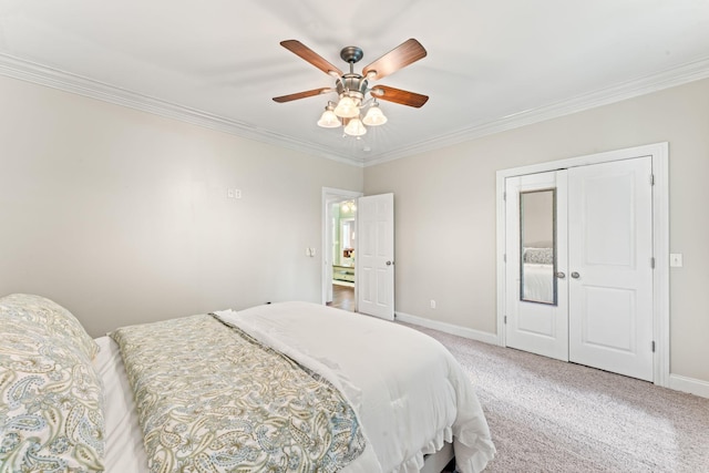 carpeted bedroom with baseboards, ornamental molding, and a ceiling fan