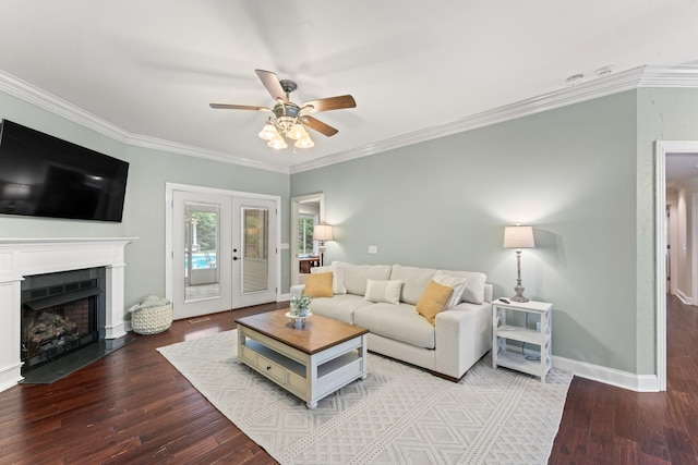 living room with wood finished floors, ornamental molding, and a ceiling fan