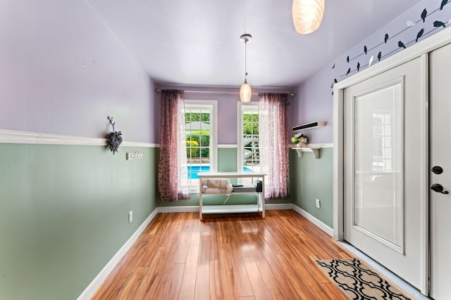 interior space featuring baseboards and light wood-style flooring