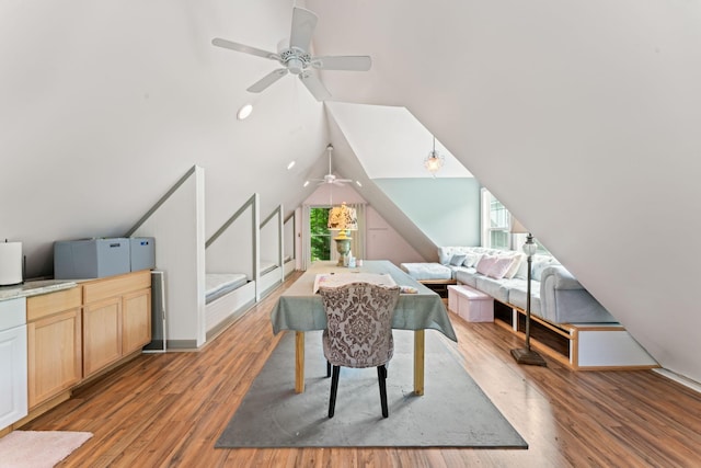 interior space with wood finished floors, lofted ceiling, and ceiling fan