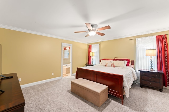 carpeted bedroom with ornamental molding, baseboards, ensuite bathroom, and ceiling fan