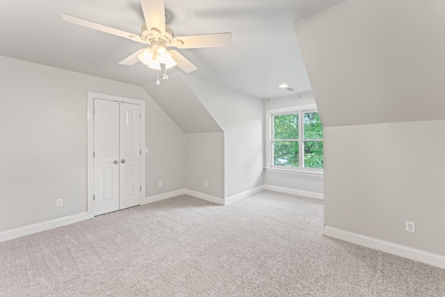 additional living space with baseboards, carpet flooring, vaulted ceiling, and a ceiling fan