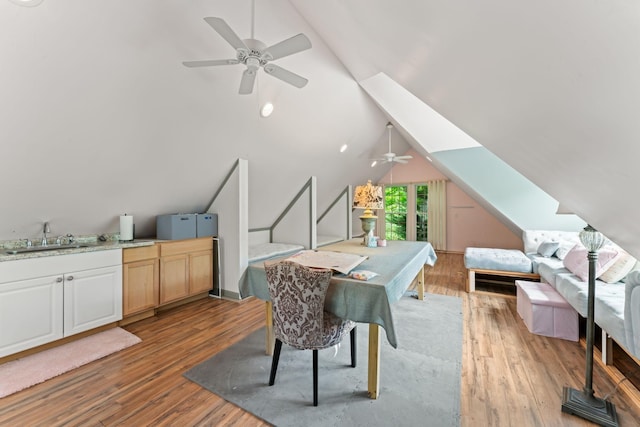 dining room featuring vaulted ceiling, light wood-style flooring, and ceiling fan