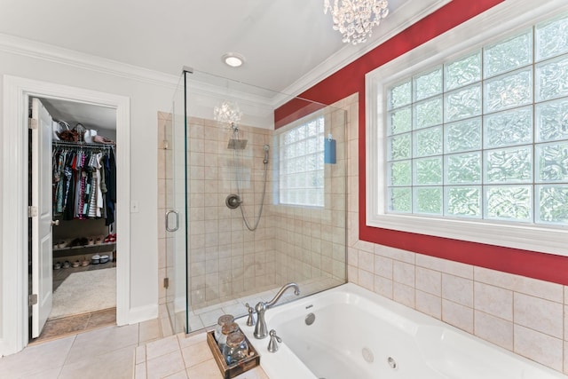 bathroom featuring tile patterned flooring, ornamental molding, a chandelier, a shower stall, and a tub with jets
