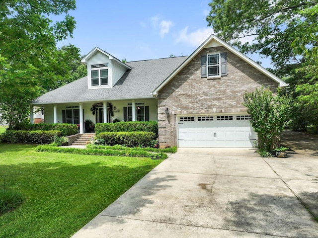 view of front of property featuring brick siding, a front lawn, concrete driveway, and a porch