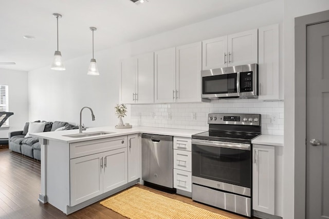 1638 54th Ave N Unit 313, Nashville, TN 37209 - kitchen with light countertops, a peninsula, stainless steel appliances, a sink, and open floor plan