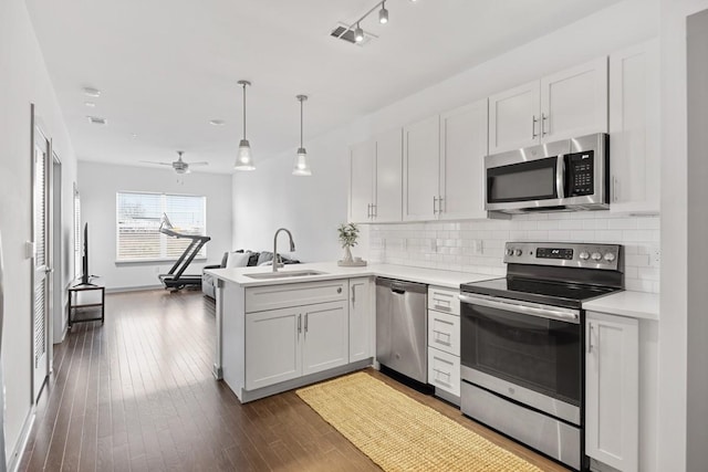 1638 54th Ave N Unit 313, Nashville, TN 37209 - kitchen with a sink, tasteful backsplash, appliances with stainless steel finishes, and a peninsula